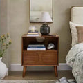 JVNOXK Mid-century modern-style recessed nightstand with open storage and drawers, featuring power outlets and four solid wood legs, walnut finish